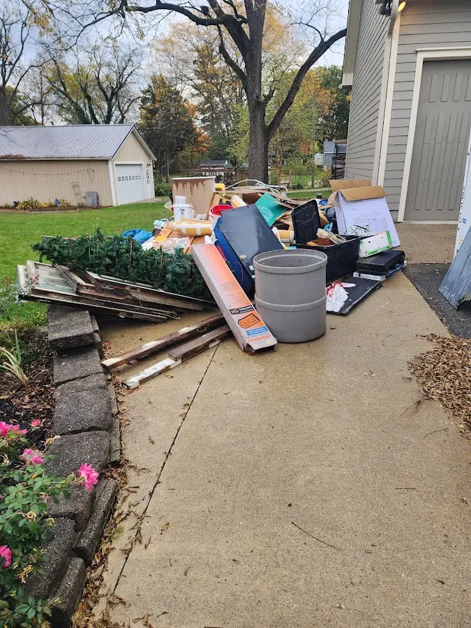Dumpster being loaded with debris for Commercial Dumpster Rental in Garden City